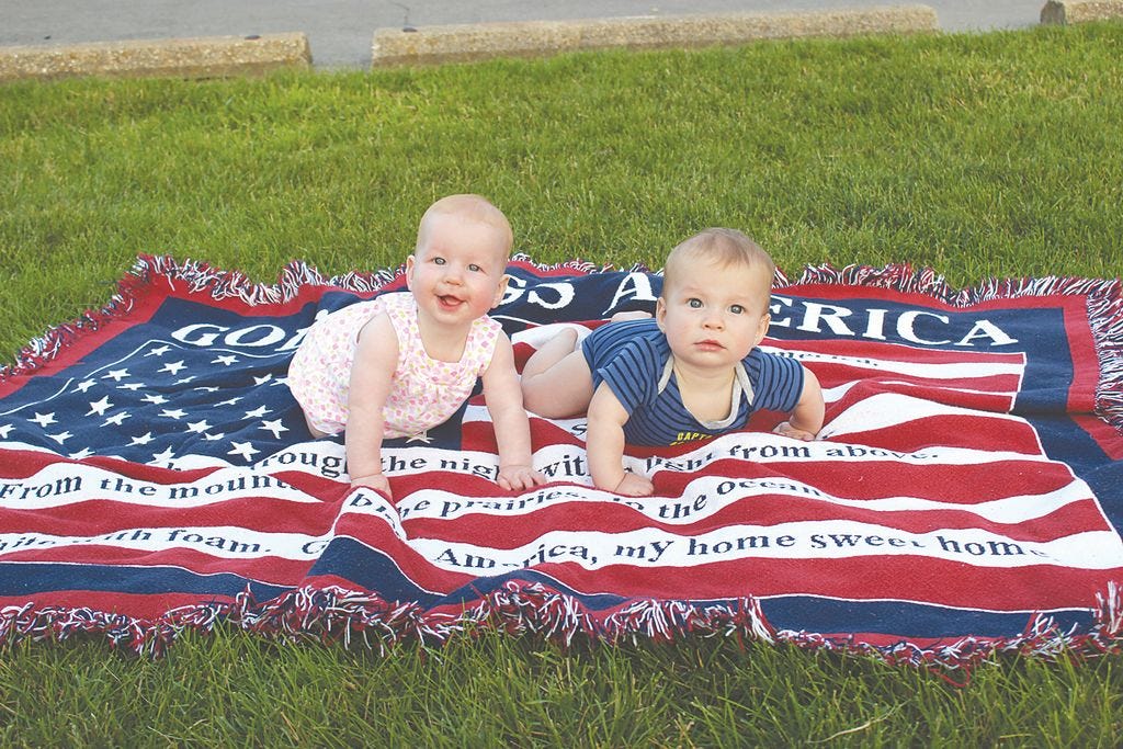 Six-month-old twins Caroline and Carter Hinkle of Greencastle are in the spirit of the holiday while enjoying an evening at Jerome R. King Playground with their parents and brother and sister, another set of twins in the family.