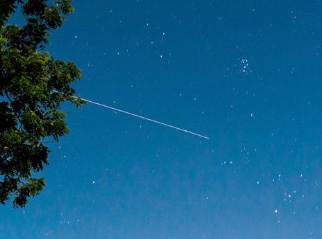 The International Space Station is seen in this 30 second exposure as it flies over Elkton, VA early in the morning, Saturday, August 1, 2015. That’s the Pleiades star cluster at upper right. Photo Credit: NASA/Bill Ingalls